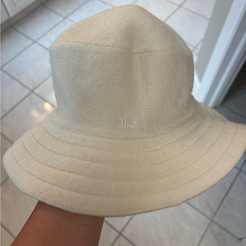 ALO Yoga Cream Bucket Hat with Black Lining and Branded Tag